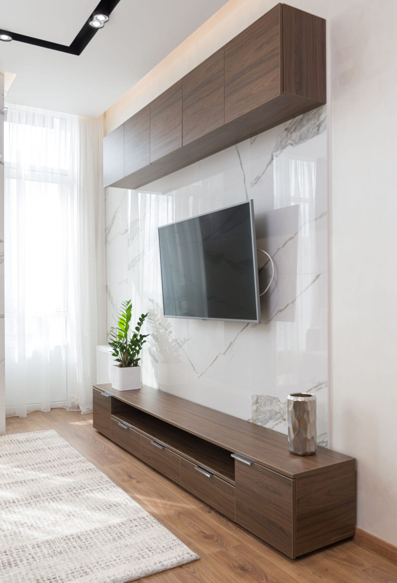 TV mounted above a tiled fireplace