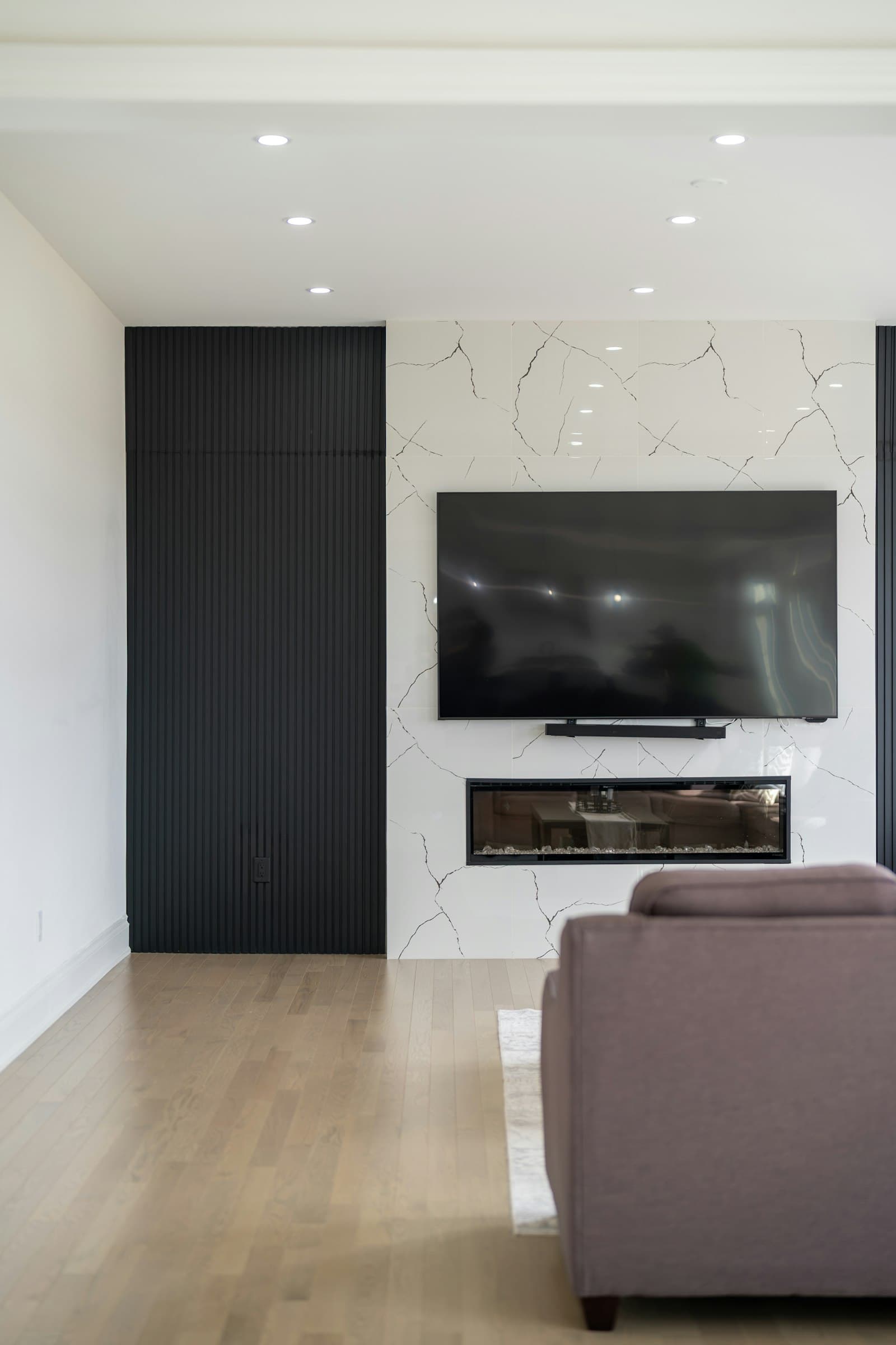 Modern living room with a TV mounted over the fireplace