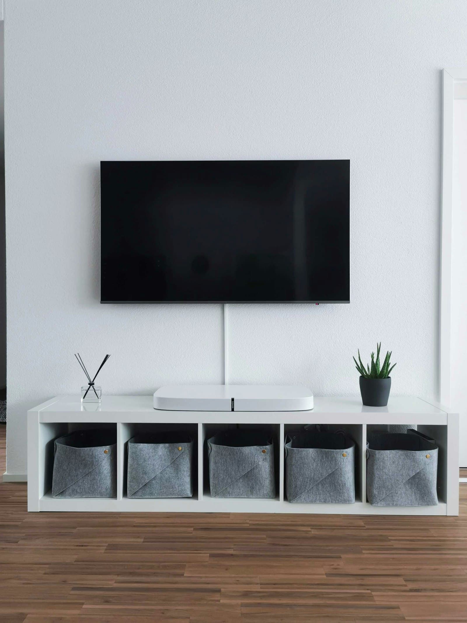 Flat screen TV mounted flush on a living room wall